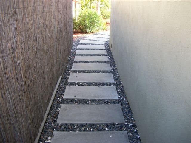 Custom concrete stepping-stone path set in decorative gravel