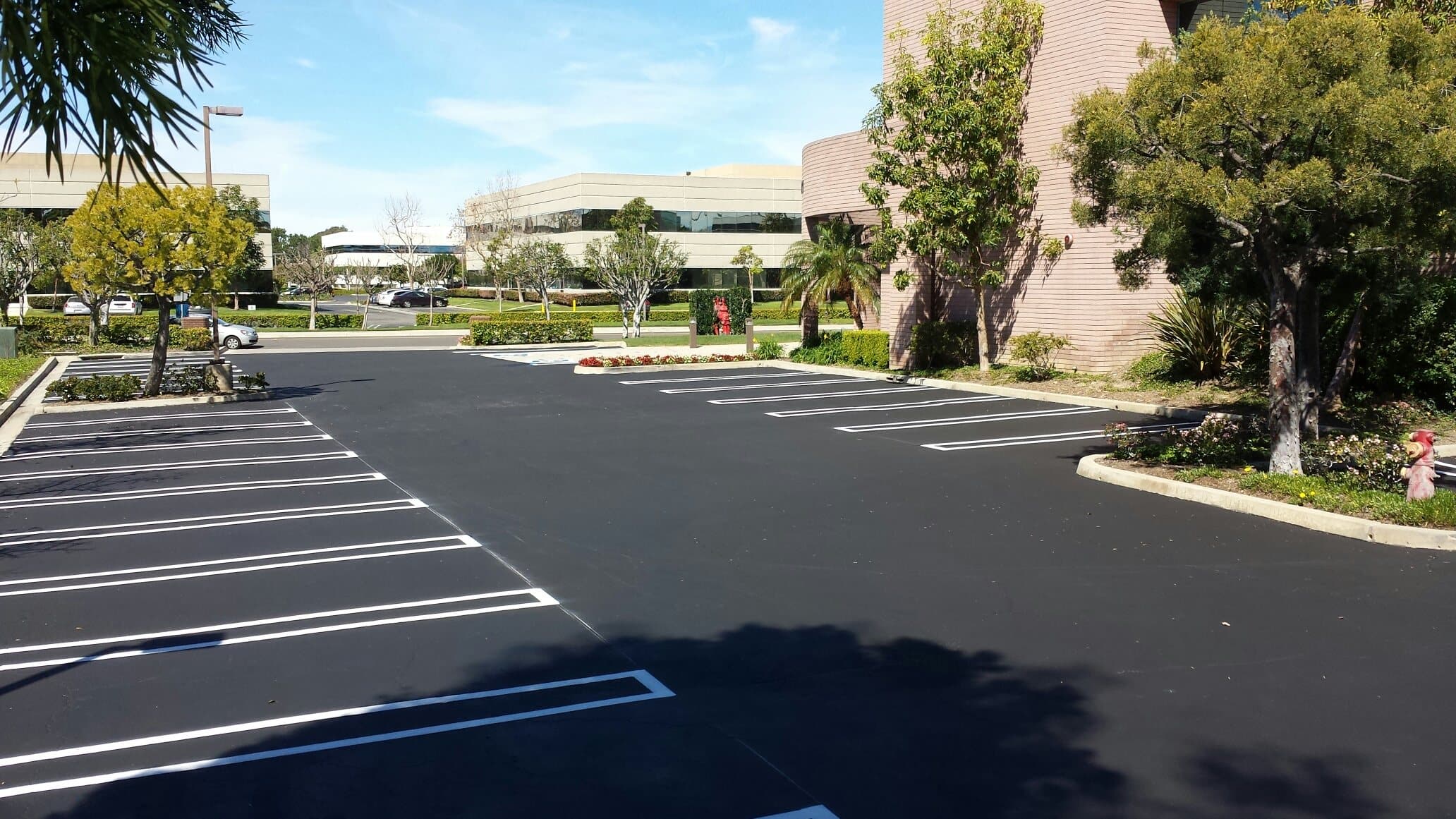 Newly sealed and restriped parking lot in Irvine with crisp white stall lines