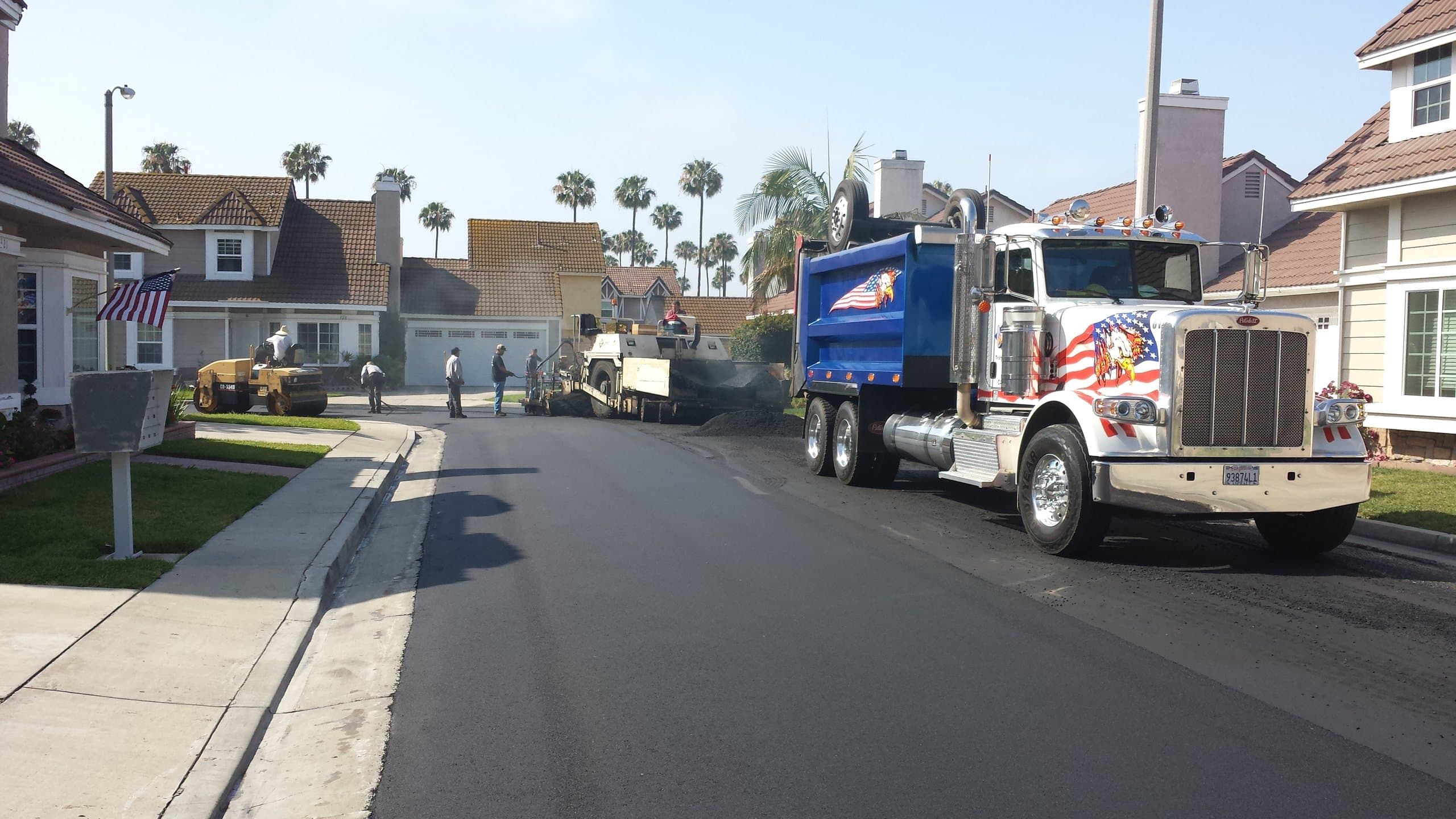 Dump truck delivering asphalt on a newly paved residential street