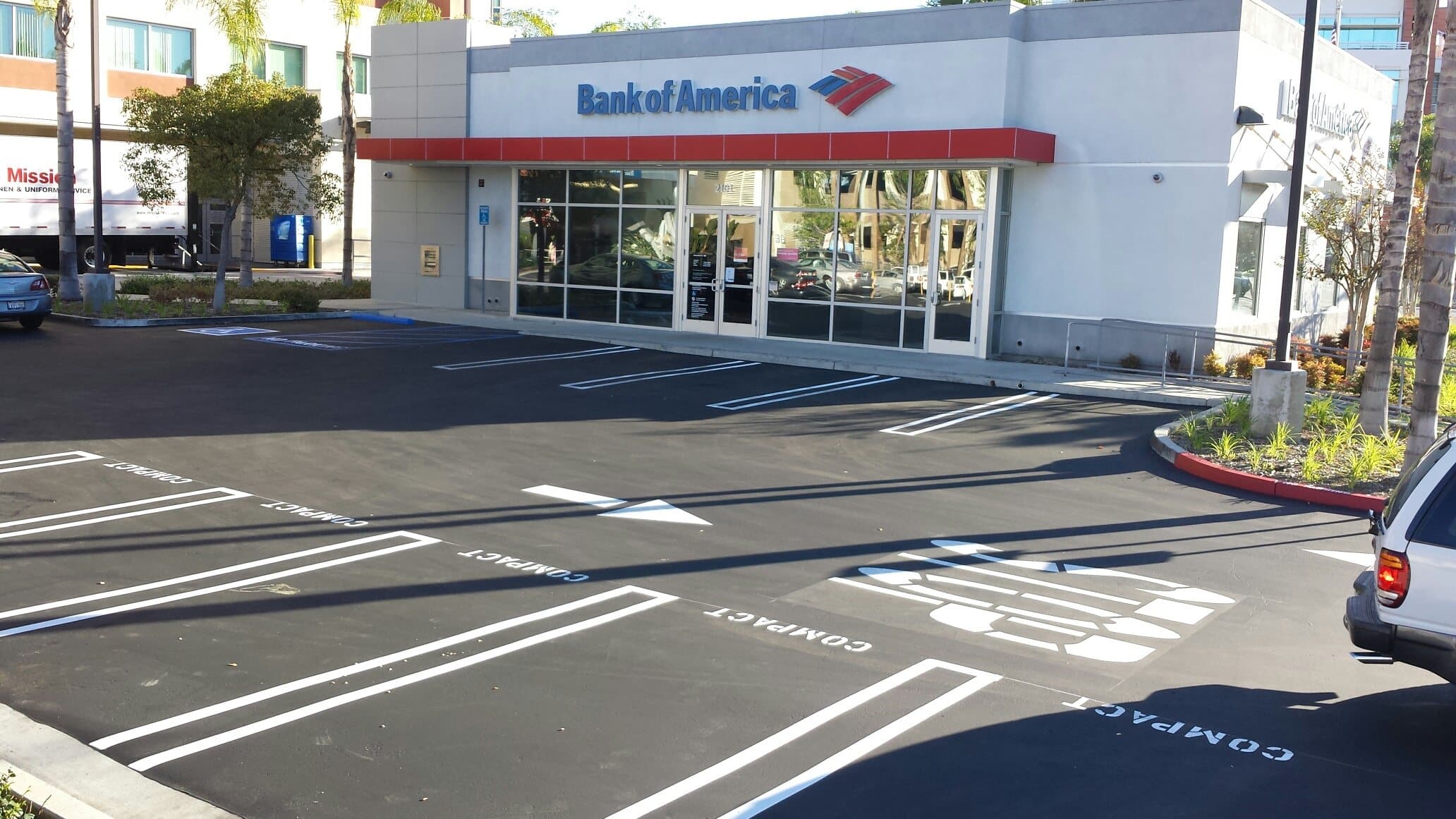 Retail bank parking lot with new striping, arrows and pavement stenciling