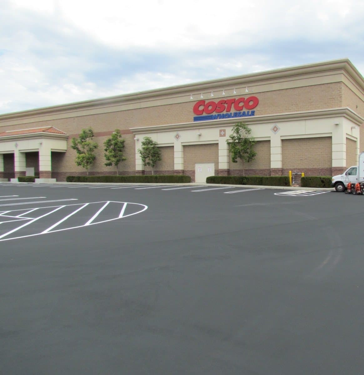 Retail warehouse parking lot after seal coating and striping